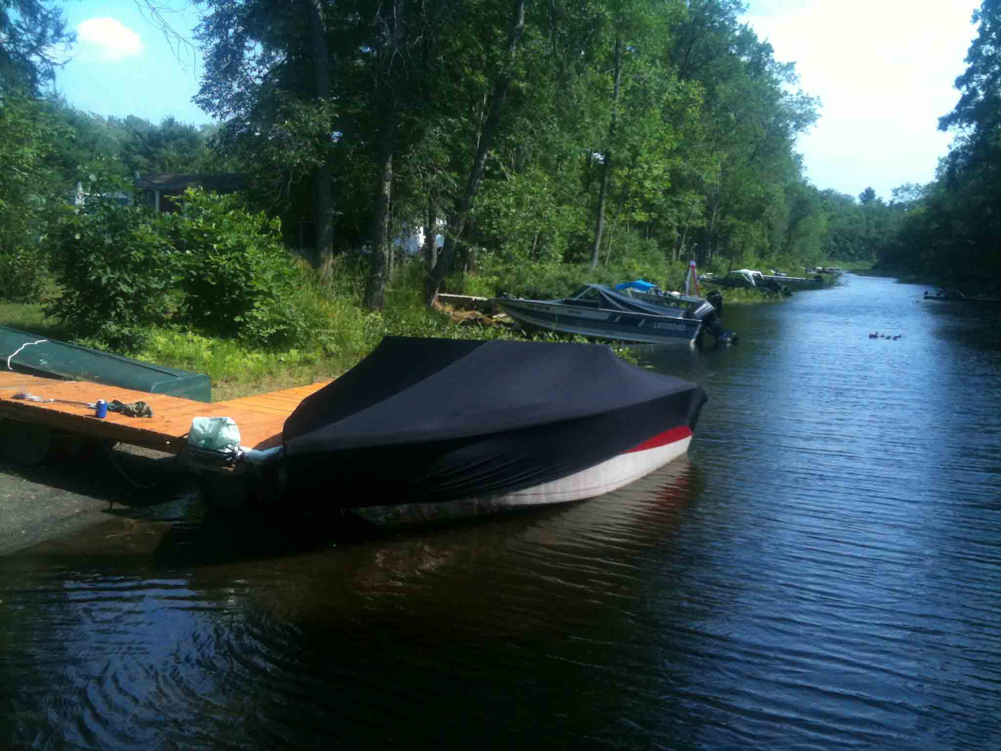 covered boat in water